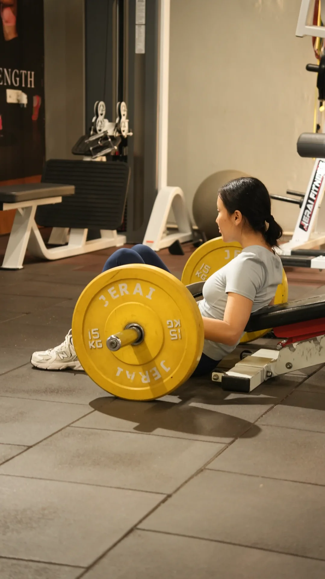 Client performing hip thrust with yellow Jerai plates